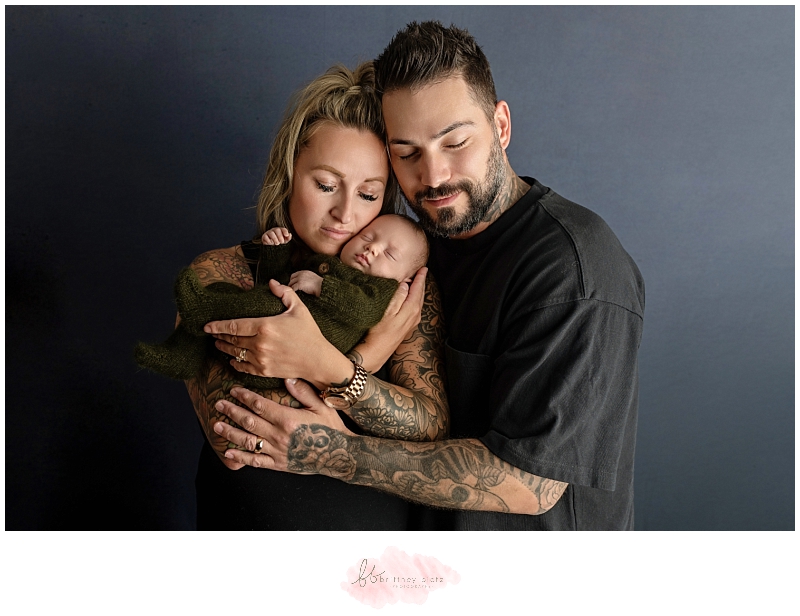 family of three posed in the studio